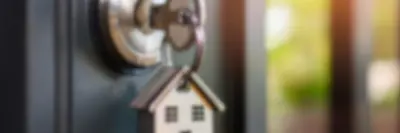 The door of a home left open with a key in the doorknob