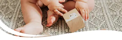 An infant playing with blocks.