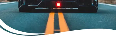 Image of a car driving on a road.