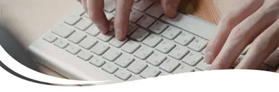 A person typing on a keyboard.