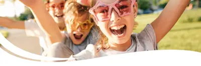 Children playing and wearing fun sunglasses.