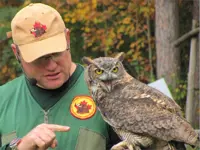 Image of a man holding an owl