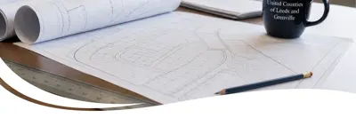 A person drawing maps with descriptions for land-use documents.