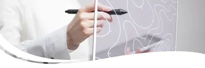 Image of a person writing on a map on a clear board.