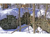 Snow-covered stone foundation