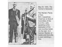 Two gentlemen planting a tree