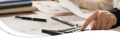 Image of documents and a calculator on a table.